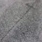 Close-up of a grey cowhide rug showing the natural hair texture and speckled salt and pepper pattern.
