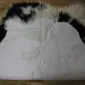Long-haired Icelandic sheepskin rug with natural black and white spots and a matching square cushion.