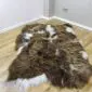 IMG_3335-min Long-haired Icelandic sheepskin rug with rusty brown, grey, and white spots on a wooden floor.