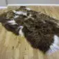 IMG_3336-min Long-haired Icelandic sheepskin rug with rusty brown and white spotted wool on a wooden floor.