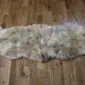 Double rare breed sheepskin rug with long, textured wool in cream, grey and brown tones.