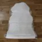 Long double sheepskin rug in cream and light grey with a thick, textured wool pile.