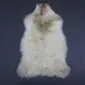 Natural cream rare breed sheepskin rug with long wool and light brown markings. detail view