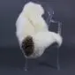 Long-pile cream sheepskin rug with a distinct dark brown patch, laid flat.