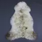 Natural rare breed sheepskin rug with cream wool and grey and brown markings.