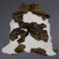 Natural calfskin rug with a white base and dark brown brindle patches.