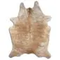 Natural cowhide rug with an irregular shape featuring exotic beige and light brown speckled patterns.