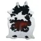 Natural cowhide rug with white, black and chestnut brown patches in a unique organic shape.