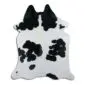 Natural shaped cowhide rug featuring a white base with large black spots and patches.