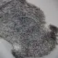 A double-sized Gotland sheepskin rug with natural grey curly wool and an irregular organic shape.