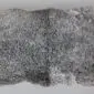 Double Gotland sheepskin rug with natural grey curly wool and an irregular organic shape.