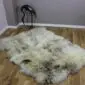 Rare-Breed British Sheepskin Quad RB4S-182 (3) Large quad sheepskin rug with long, cream and grey mottled wool pile on a wooden floor.