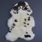 Rare Breed Sheepskin Rug RBM-83 (2) Natural cream sheepskin rug with dark brown spots and markings in a traditional pelt shape.