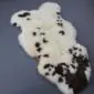 Rare Breed Sheepskin Rug RBM-83 (3) Natural rare breed sheepskin rug with cream wool and dark brown spots in an irregular shape.