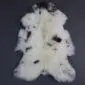 Cream rare breed sheepskin rug with dark brown and black spots and long, textured wool.