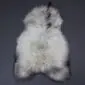 Long-haired Icelandic sheepskin rug in white with natural grey and black markings.