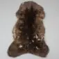 Large rare breed sheepskin rug with thick, dark brown and mottled tan wool in a natural pelt shape.