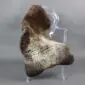 Large rare breed sheepskin rug with natural dark brown and cream mottled wool laid flat.