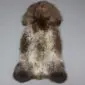 Large rare breed sheepskin rug with long, textured wool in mottled shades of dark brown, grey and cream.