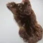 Large rare breed sheepskin rug with thick, curly dark brown wool and natural organic shape.