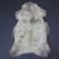 Large rare breed sheepskin rug with long, cream and grey textured wool in a natural pelt shape.