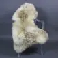 Large rare breed sheepskin rug with long, thick wool in cream and mottled brown tones laid flat.