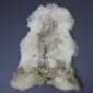Large rare breed sheepskin rug with natural cream, grey and brown wool markings in a pelt shape.
