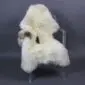 Large rare breed sheepskin rug in cream with natural brown markings and long wool pile.