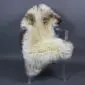 Large rare breed sheepskin rug with long cream wool and brown markings laid flat.