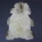 Large rare breed sheepskin rug with thick cream wool and natural brown markings around the edges.