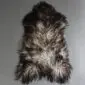 Natural grey Icelandic sheepskin rug with long, curly wool in variegated shades of charcoal and silver.