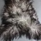 Natural grey Icelandic sheepskin rug with long, curly wool in variegated shades of charcoal and silver. detail view