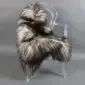 Natural grey Icelandic sheepskin rug with long curly wool laid flat.