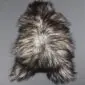 Natural grey Icelandic sheepskin rug with long, curly wool in variegated shades of charcoal, silver and white.