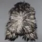 Natural grey Icelandic sheepskin rug with long, curly wool in variegated shades of charcoal and silver.
