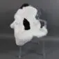 Icelandic Sheepskin Rug IMX132 (2) Shorn Icelandic sheepskin rug in white with a central black patch, laid flat.