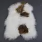 Icelandic Sheepskin Rug ISM388 (3) Long-haired white Icelandic sheepskin rug with natural brown spots and an irregular organic shape.