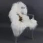 Long-haired white Icelandic sheepskin rug with natural brown markings laid flat.