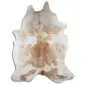 Natural shaped cowhide rug with speckled light brown and white markings.