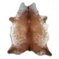 Natural cowhide rug with tan brown and white speckled markings and an irregular organic shape.