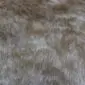 Natural cowhide rug with a speckled beige and brown pattern and organic shape.