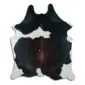 Natural cowhide rug with large dark brown and black patches on a white background.