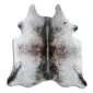 Natural shaped cowhide rug with white base and brown speckled markings.