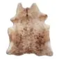 Natural cowhide rug with a speckled brown and cream pattern in a traditional animal hide shape.