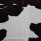 Cowhide Rug C00974 (1) Natural cowhide rug with large black and white patches and an irregular organic shape.