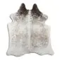 Natural cowhide rug with white and grey speckled patterns and dark brown patches at the top.