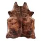 Natural cowhide rug with a brindle pattern in shades of brown, tan, and black.