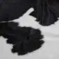 Cowhide Rug C01017 (4) Close-up of a black and white cowhide rug showing natural hair texture and organic spotted patterns.