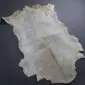 Goatskin Rug G1004 (4) Natural goatskin rug with grey and cream mottled fur and an irregular organic shape.