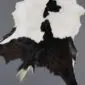 Natural goatskin rug with irregular patches of black, dark brown and white fur.